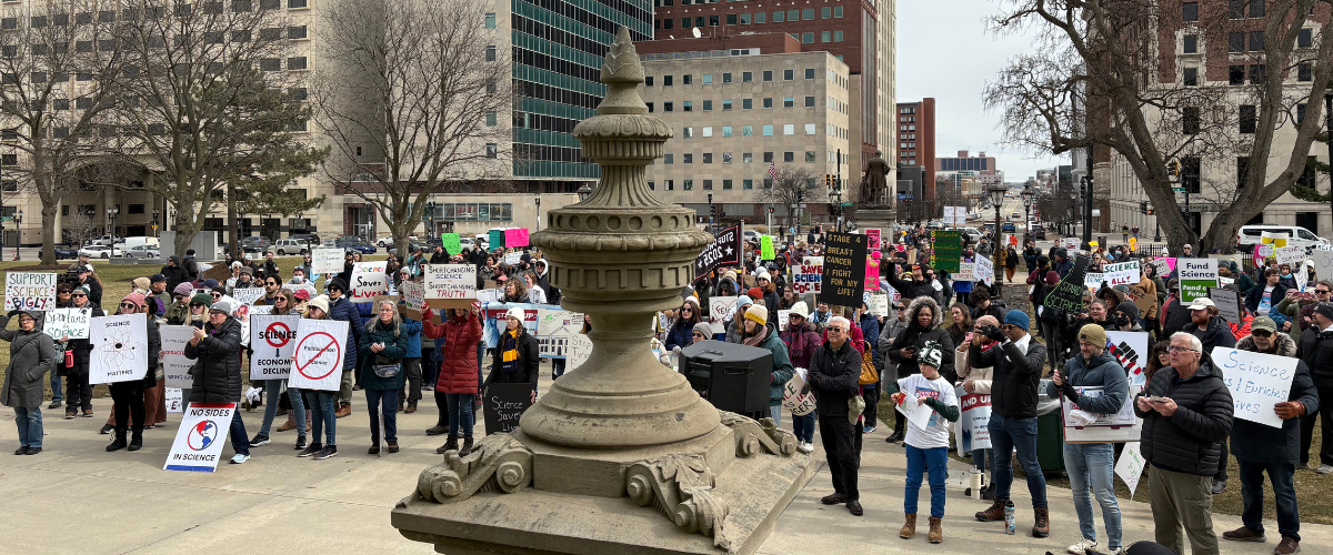 Stand up for Science rally participants gathered in front of the capitol building in Lansing, Michigan.